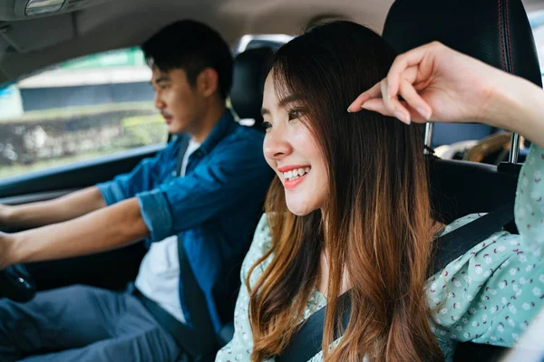 stock image Cheerful asian thai couple sitting at passenger front seat. Road trip with boyfriend.