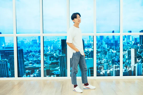 Teenage Guy Jeans White Shirt Standing Wooden Floor Next Glasses — Stock fotografie