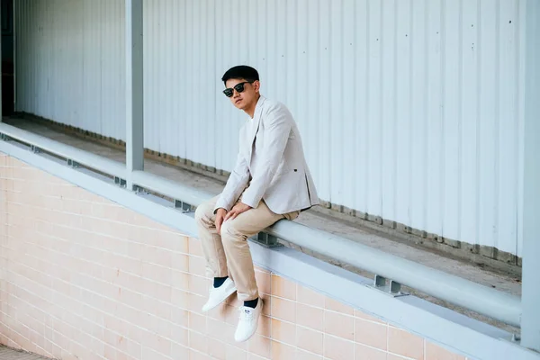 Man White Suit Wearing Sunglasses Sitting Handrail Slope Path Building — Stock Photo, Image