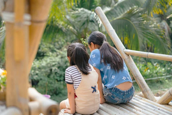 Pohled Zezadu Dvě Asijské Holčičky Sedící Okraji Dřevěné Kavárny Bambusu — Stock fotografie