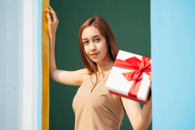 Kırmızı kurdeleli güzel esmer kadın hediye paketi .