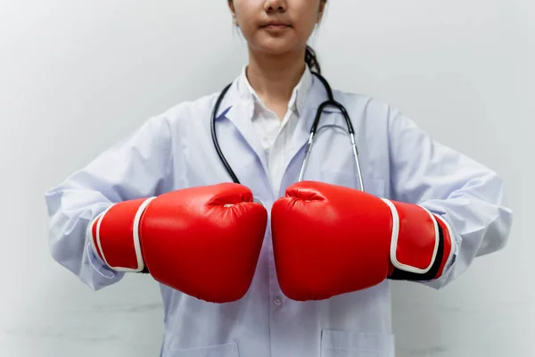 Cropped image of red mitts cover doctor\'s hands while she do the knuckle bump.