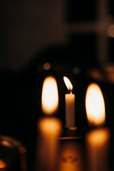 Candles light burning at night in the dark room.