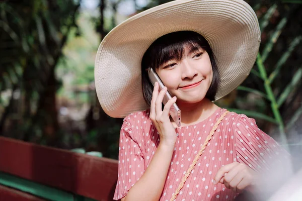 아름다운 아시아인 스마트폰을 사용하여 모자를 머리를 — 스톡 사진