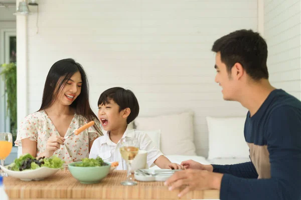Happy asian family having lunch or breakfast together at home