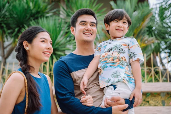 Portrait of cheerful and happy asian thai family spending time together outdoors wear casual outfit.