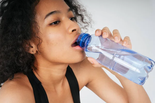 Şişeden su içen Afrikalı ve Taylandlı kadın portresi..