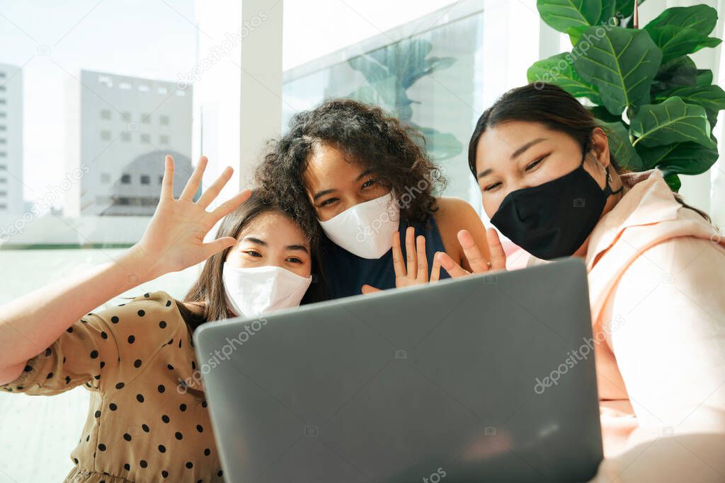 Group of diverse women wear mask doing streaming with computer laptop at home.