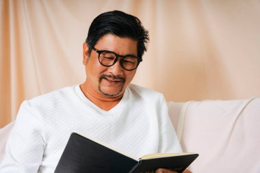Hipster, yaşlı, gözlüklü, kitap okuyan yaşlı bir adamın portresi..