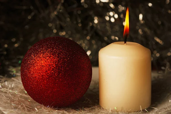 Sobre una vela de fondo multicolor y bolas de Navidad . —  Fotos de Stock