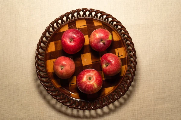 five red apples on the bowl are isolated on a white background, healthy farm food