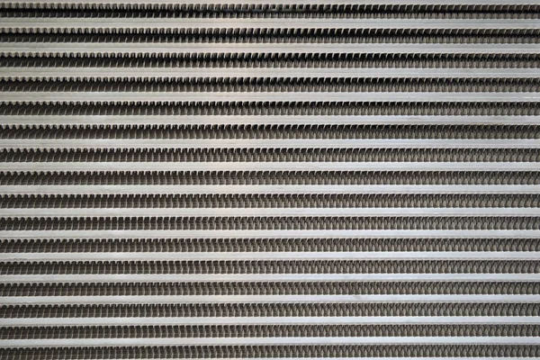 Light grey surface of a latticed metal fence with jagged stripe elements — Stock Photo, Image