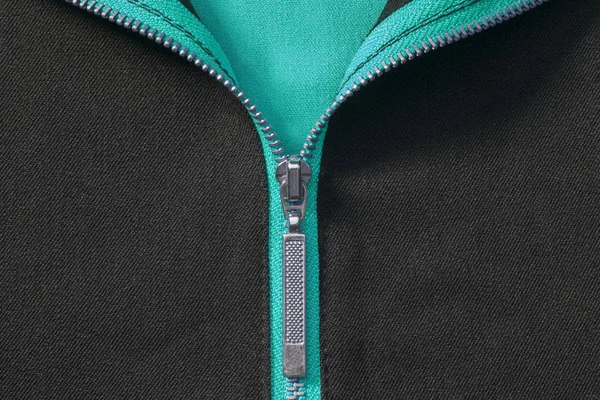 Siyah ve mavi renkli kumaş üzerinde yarım açık gümüş zip — Stok fotoğraf