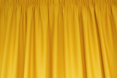 Kumaş sarı perdeler. Soyut arkaplan, perde, altın kumaş perdeler.