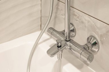 Bath water faucet with thermostate handles clipart