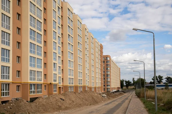 View on construction place with dirt land and unfinished residential houses