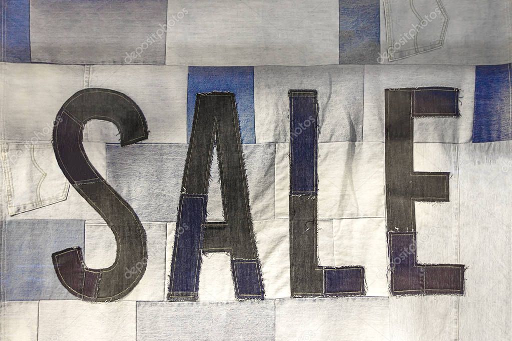 Season sale, black friday and creative shopping concept. Sale sign made from denim.