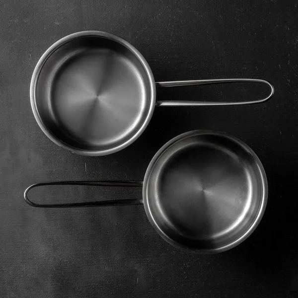 Two Silver Metal Pans Black Textured Cement Background Template Utensil — Stock Photo, Image