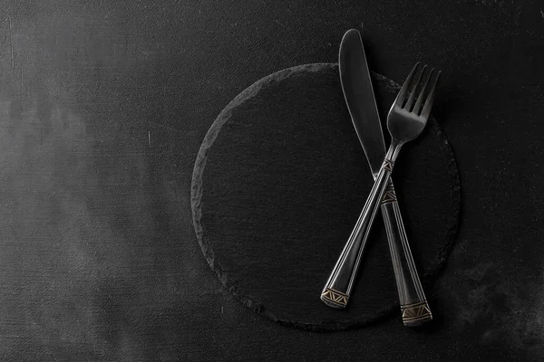 Empty Black Stone Board Crossed Cutlery Fork Knife Black Cement — Stock Photo, Image