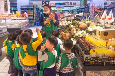 Taipei, Taiwan - March 25, 2018: Children on excursion in shop clipart
