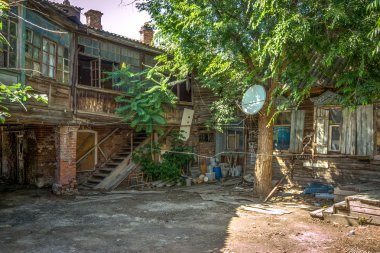 Astrakhan, Russia - June 20, 2016: local yard with tree clipart