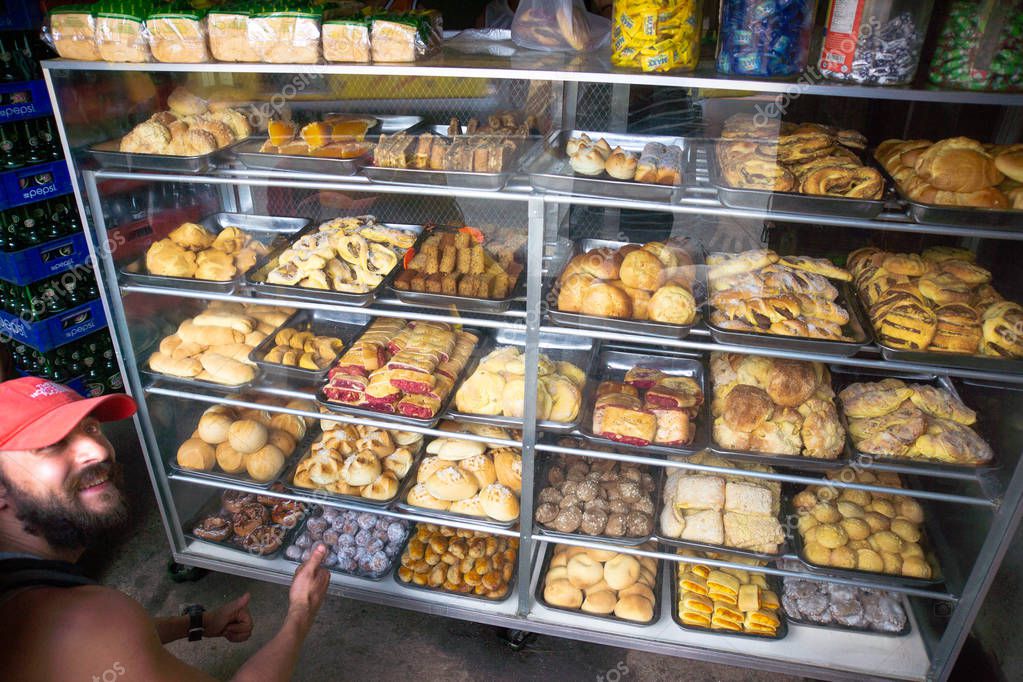 Cebu, Philippines - November 9, 2016: White man in bakery shop which is full of buns