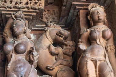 Statues and view inside Khajuraho temple, India. clipart