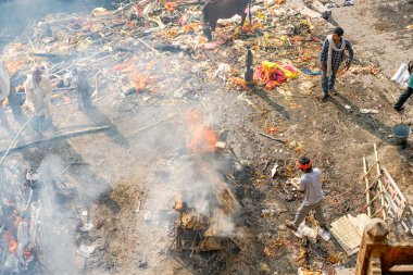 Varanasi, India - July 13, 2019: Ritual of burning dead body clipart