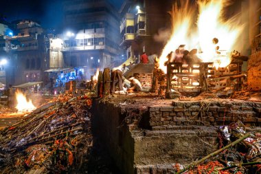 Varanasi, India - July 13, 2019: Ritual of burning dead body clipart