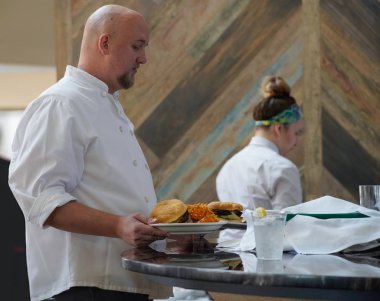  Serving staff bringing lunch to the visitors of Arizona Downs, Prescott Valley, Arizona on August 10, 2019.                                clipart