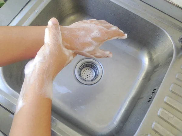 Wash your hands with soap on the sink.  Hand wash for good hygiene. How to wash hands properly.