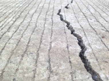 Cracks, crevices, concrete slabs this is caused by the non-standard construction. Crack of the road. clipart