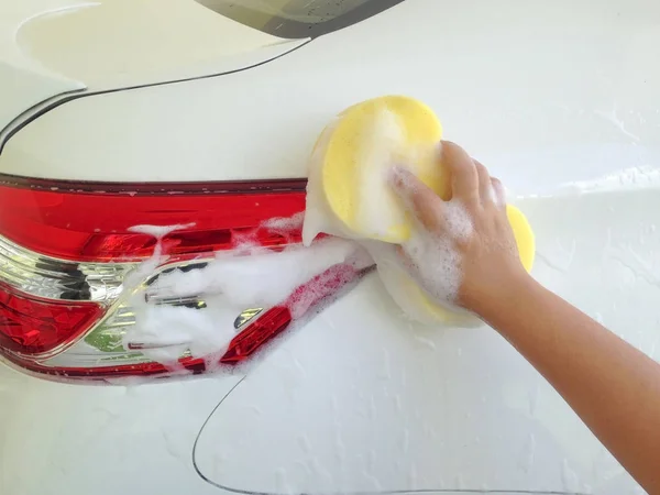 Car Wash with car shampoo and sponge.