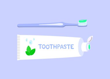 Bitkisel diş macunu ve diş fırçası mavi arka plan üzerinde izole. 