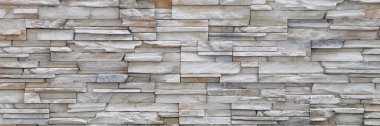 Stone background walls are stacked. Stone cladding background and wallpaper. clipart