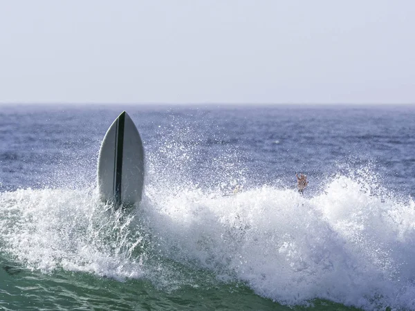 Surfers board taking off  from wave — Stock Photo, Image