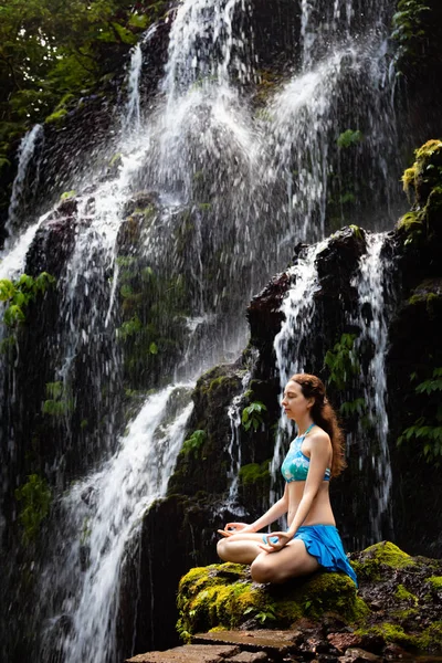 Giovane donna caucasica meditare, praticare yoga a cascata. Mudra di Gyan. Cascata di Banyu Wana Amertha Wanagiri, Bali, Indonesia . — Foto Stock