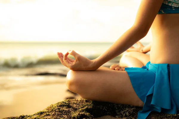Yoga pose, gyan mudra close up. Young woman meditating, practicing yoga and pranayama with gyan mudra at the beach, Bali
