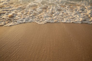 Manzaralı deniz manzarası. Kumsalda köpüklü dalgalar. Gün batımı zamanı. Arka plan için su manzarası. Seçilmiş yumuşak sanat odağı. Suya ve ıslak kuma güneş ışığı yansıması. Uzayı kopyala Balangan Sahili, Bali, Endonezya