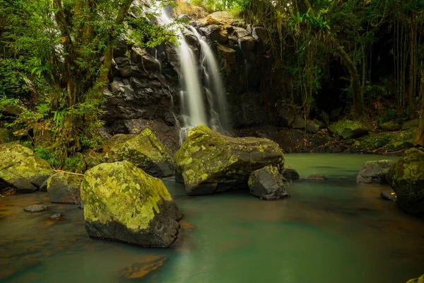 Tropical landscape. Beautiful hidden waterfall in rainforest. Adventure and travel concept. Nature background. Slow shutter speed, motion photography. Sing Sing Angin waterfall Bali, Indonesia