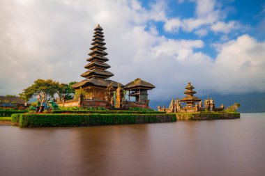 Bali adasındaki Pura Ulun Danu Bratan tapınağı. Güzel bale tapınağı. Bali 'nin simgesi. Bulutlu gökyüzü. Su yansıması. Kapama hızı yavaş. Bratan Gölü, Bali, Endonezya