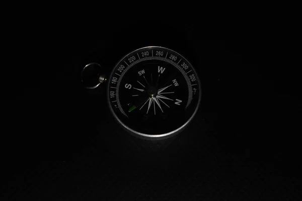 Small pocket compass isolated on black background — Stock Photo, Image