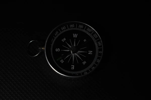 Small pocket compass isolated on black background — Stock Photo, Image