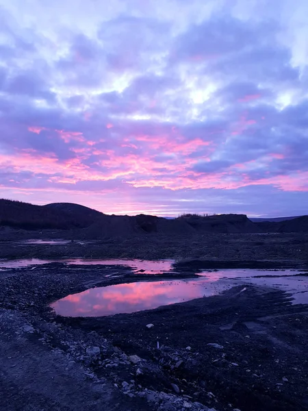 Red sunset, red sky. Landscape with hills and a lake.