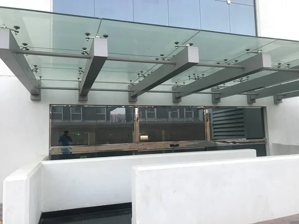 Heavy duty Glass portico or canopy supported by Aluminum steel beams for the entrance of an government office