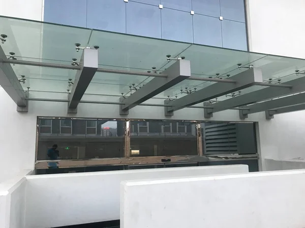 Heavy duty Glass portico or canopy supported by structural steel beams for the entrance of an government office