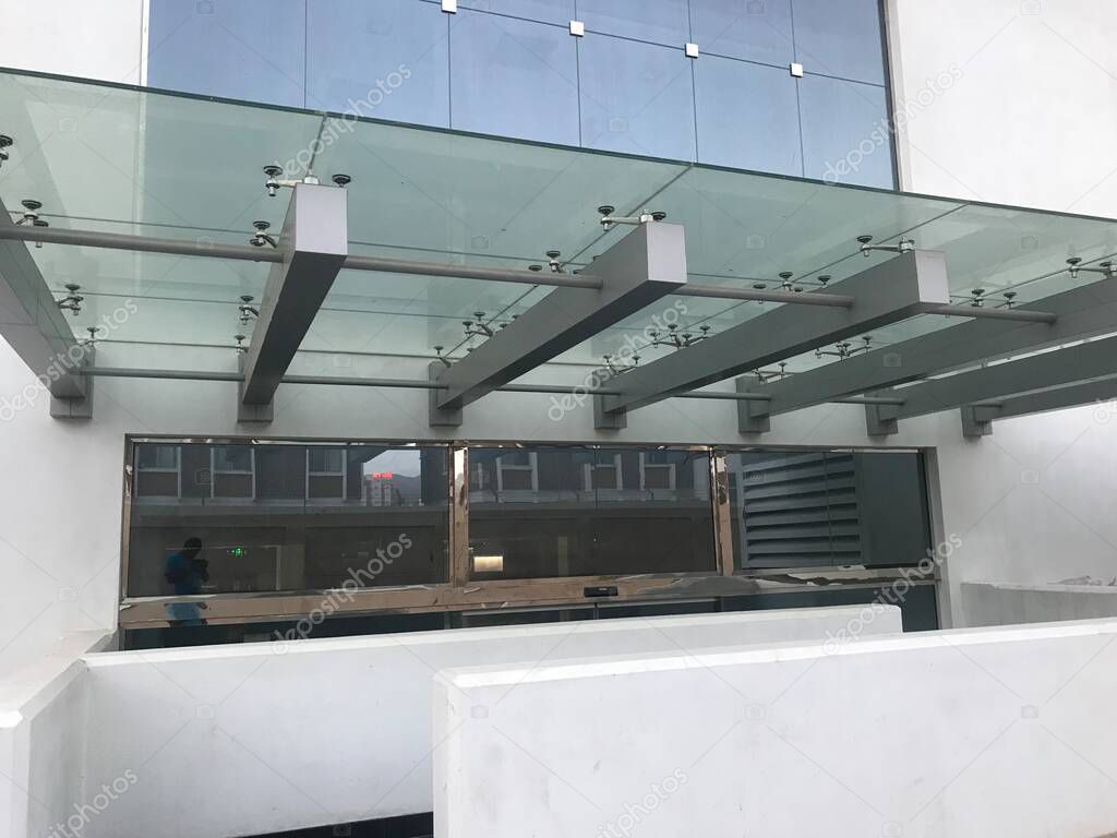 Heavy duty Glass portico or canopy supported by structural steel beams for the entrance of an government office