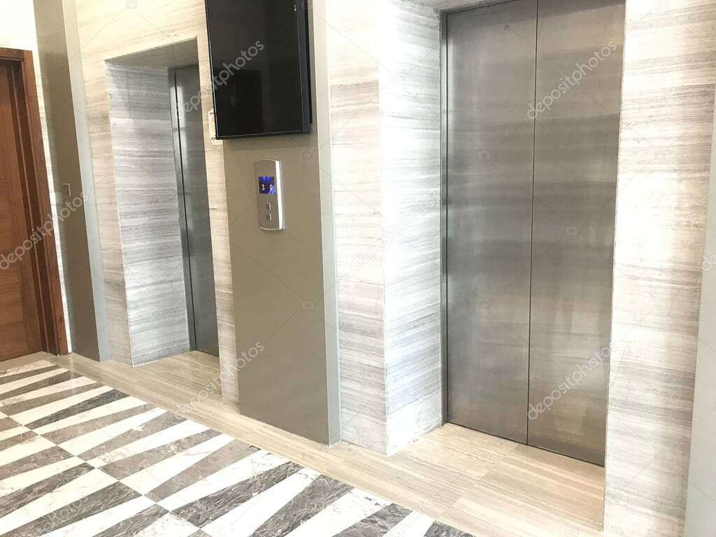Busiest office lifts are now looking empty all the time due to corona disease outbreak became pandemic and transmission between people by coughing and sneezing water droplets