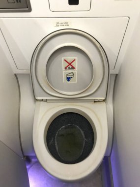 Şişkonun rahat edemediği bir uçakta Batı tuvaletini daralt.