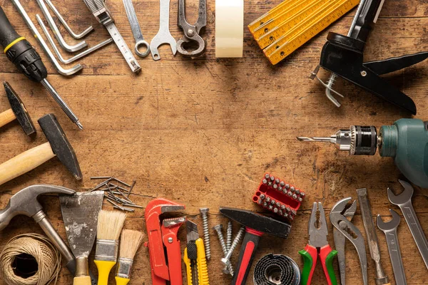 Many tools on a wooden vintage background and a space for logo